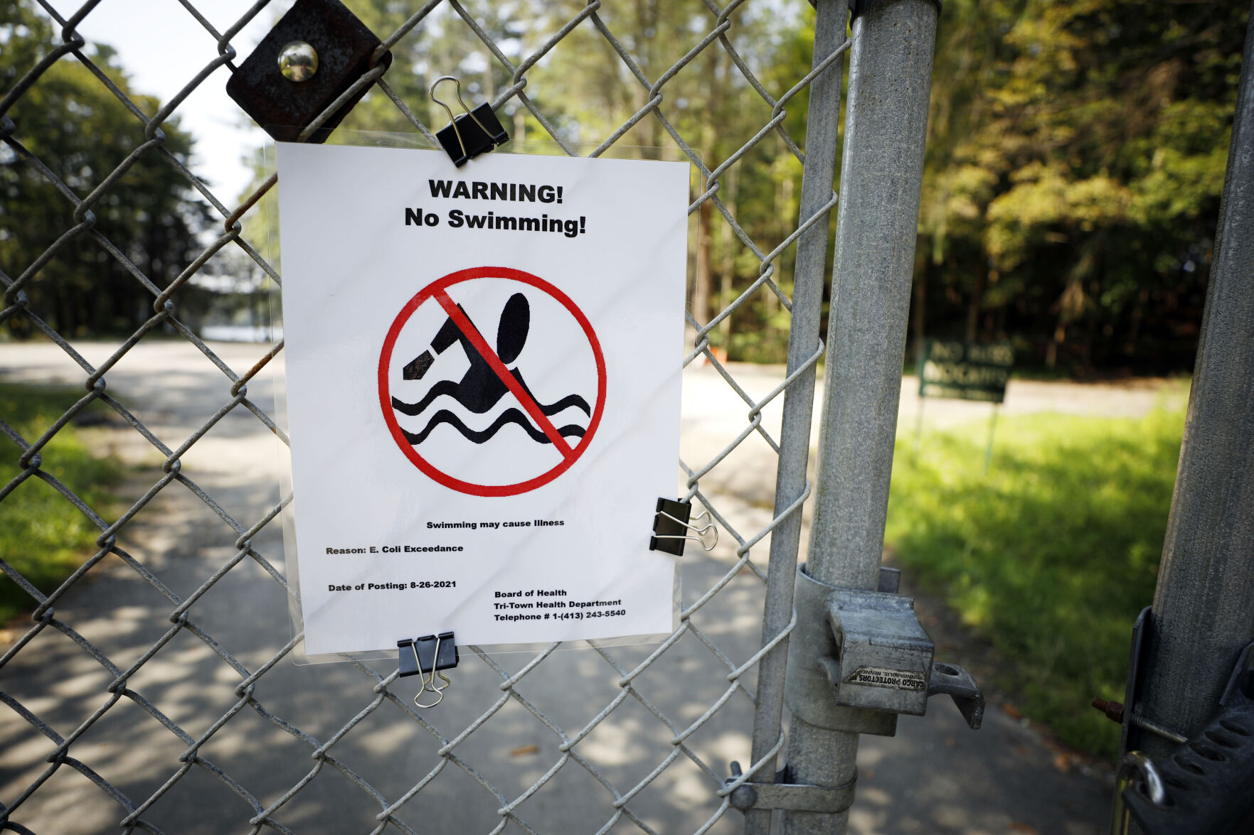 no swimming warning sign about e. coli posted on beach gate (copy)